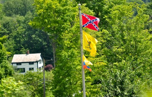 The confederate battle flag flying at our neighbors home, above the Gadsen "Don't Tread on Me" flag and the flag of Columbia below it. In the distance is our ancestral farmhouse, built circa 1810.