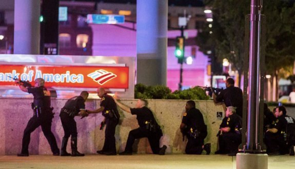 Dallas police respond to an organized sniper assault on cops at a protest against police abuse